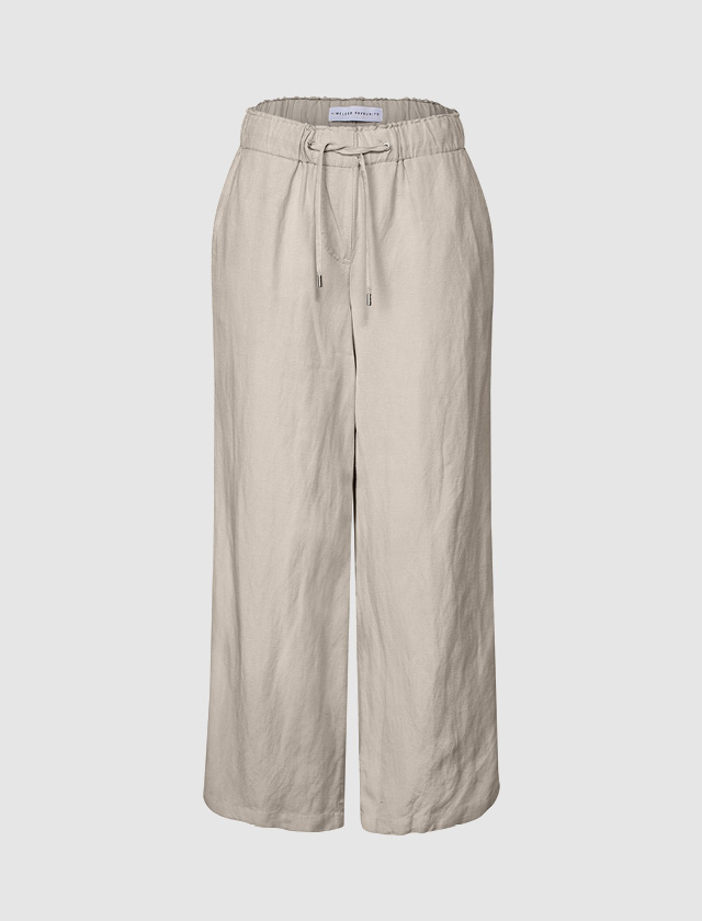 Beige lockere Damenhose mit elastischem Bund und Kordelzug. Beige lockere Damenhose mit elastischem Bund und Kordelzug.