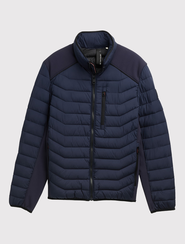 Dunkelblaue Steppjacke mit Reißverschluss, Stehkragen und Brusttasche mit Reißverschluss. Dunkelblaue Steppjacke mit Reißverschluss, Stehkragen und Brusttasche mit Reißverschluss.